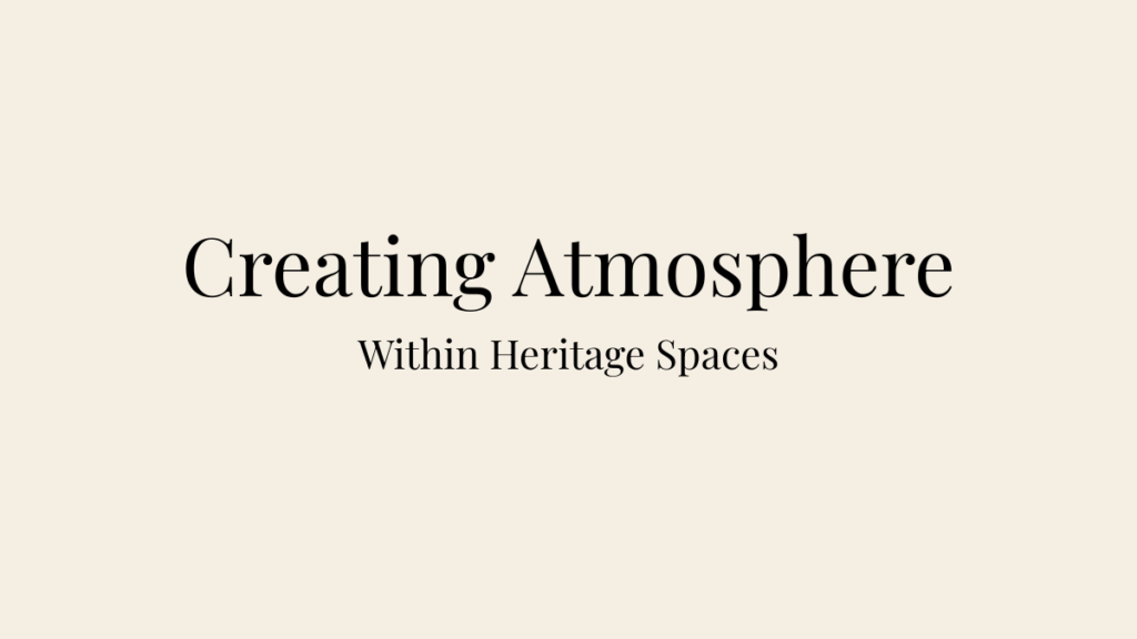 Editorial blog banner on a warm ivory background featuring the headings "Creating Atmosphere" and "Within Heritage Spaces" in elegant serif typography.